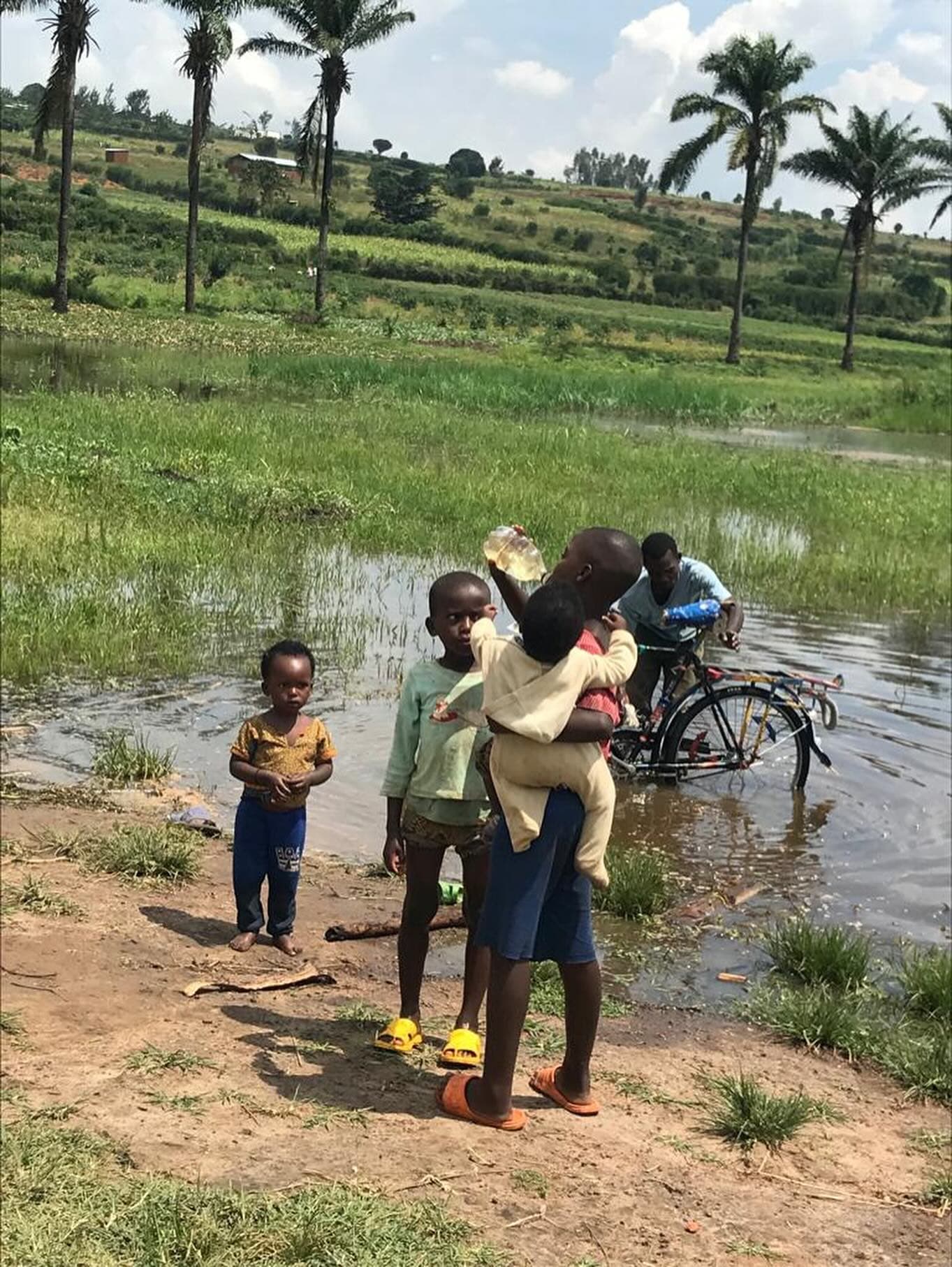 Community members carrying water in Gashora, Bugesera, Rwanda.
